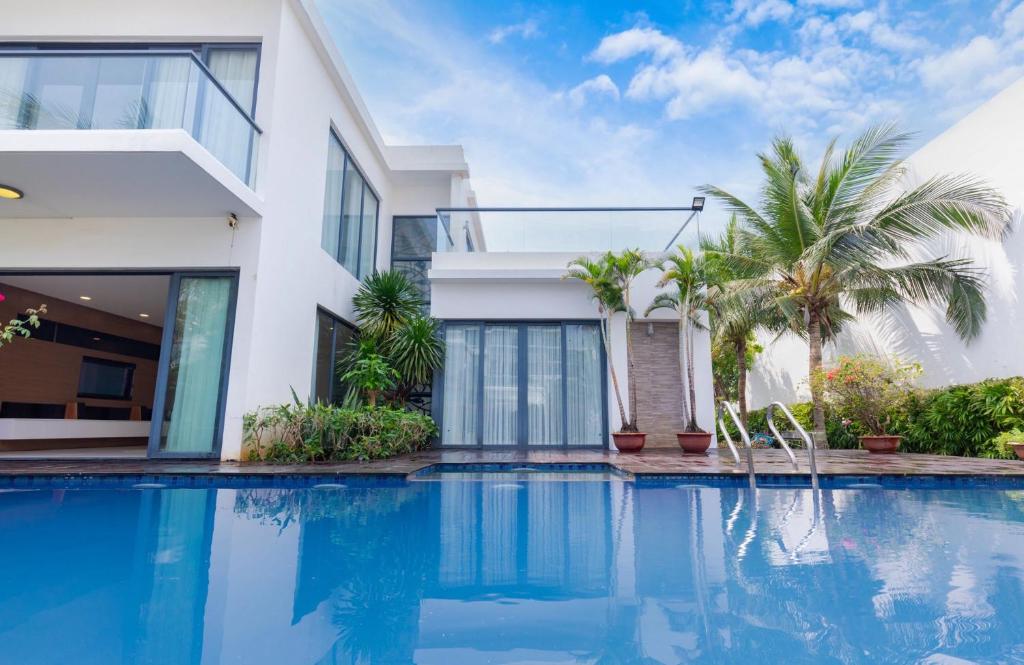 a house with a swimming pool in front of it at La Luxury Villas - Vung Tau in Vung Tau