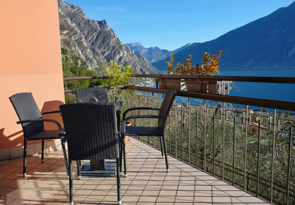 a balcony with chairs and a view of the mountains at Mont&Lac in Limone sul Garda