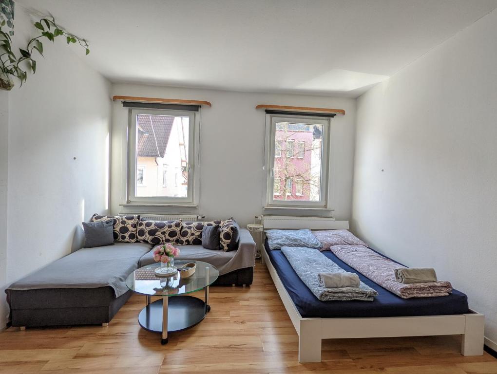 a living room with a couch and a table at Cozy Room in a Sharing Apartment WG in the black forest in Villingen-Schwenningen