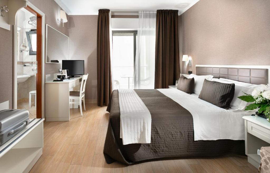 Postel nebo postele na pokoji v ubytování Hotel Ambasciatori