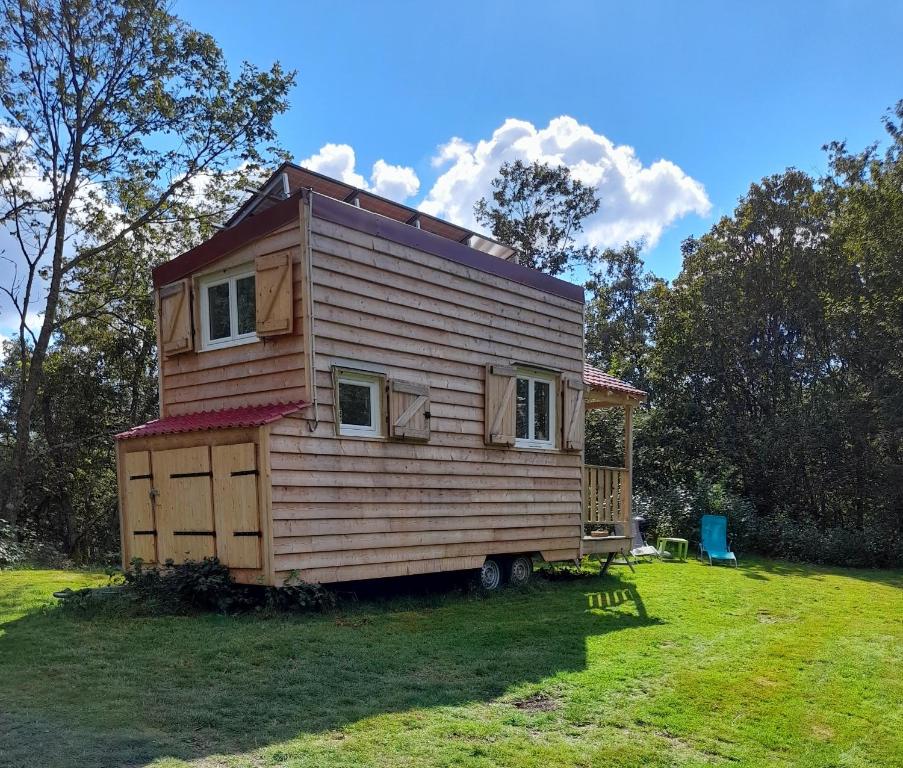a tiny house sitting on top of a yard at Tiny des Rêves in Beulotte-Saint-Laurent