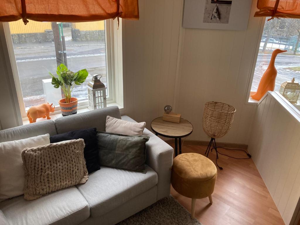 a living room with a couch and a table at Downtown Historical House with Renovated apartments in Ålesund