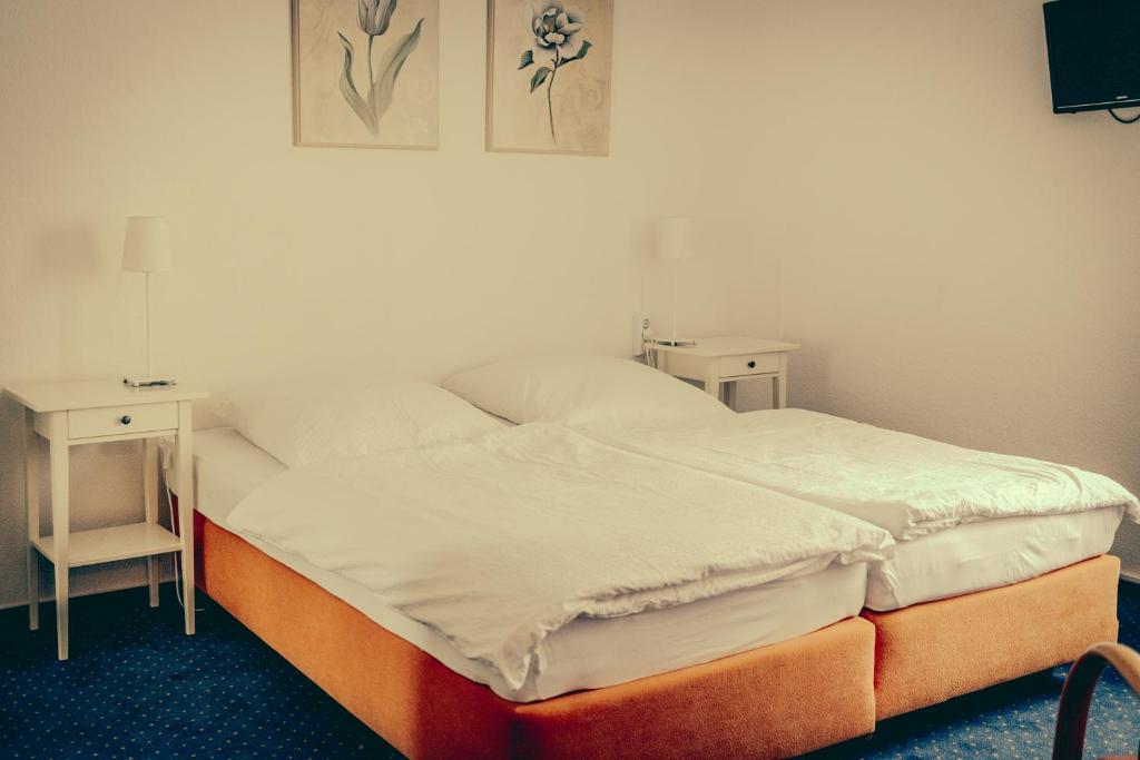 Postel nebo postele na pokoji v ubytování Inselgaestehaus-Erna
