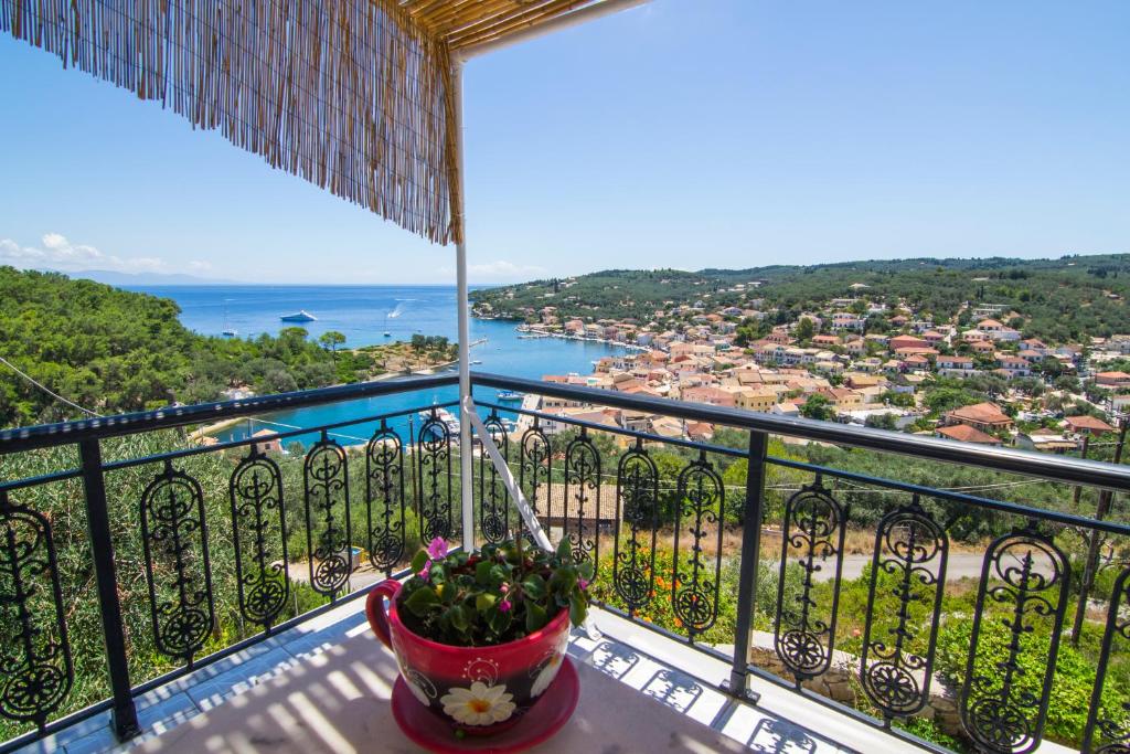 a balcony with a view of a city and the ocean at Marina's House in Gaios