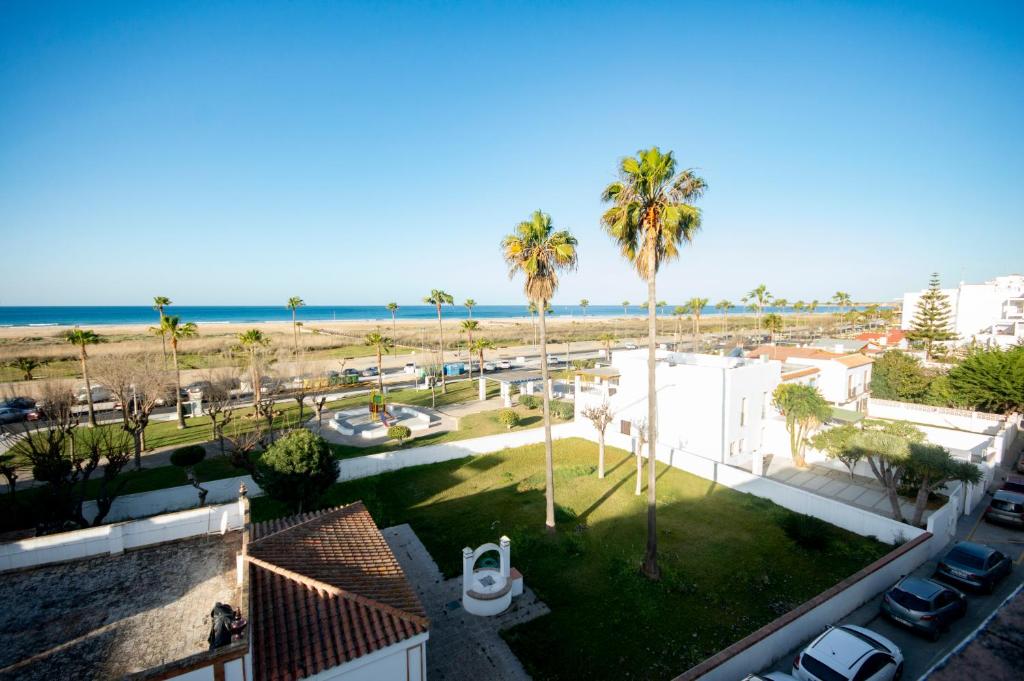 a view of the beach from the balcony of a house at Apartamento con Vistas al mar in Conil de la Frontera