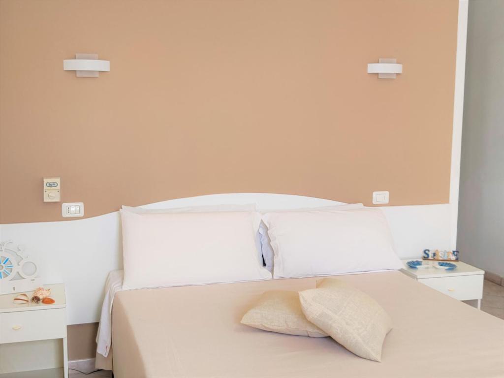 Postel nebo postele na pokoji v ubytování Hotel Baia del Cigno