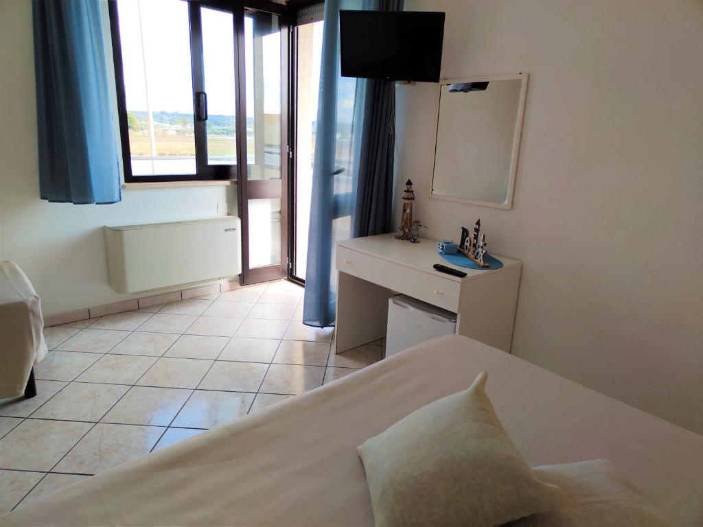 Postel nebo postele na pokoji v ubytování Hotel Baia del Cigno