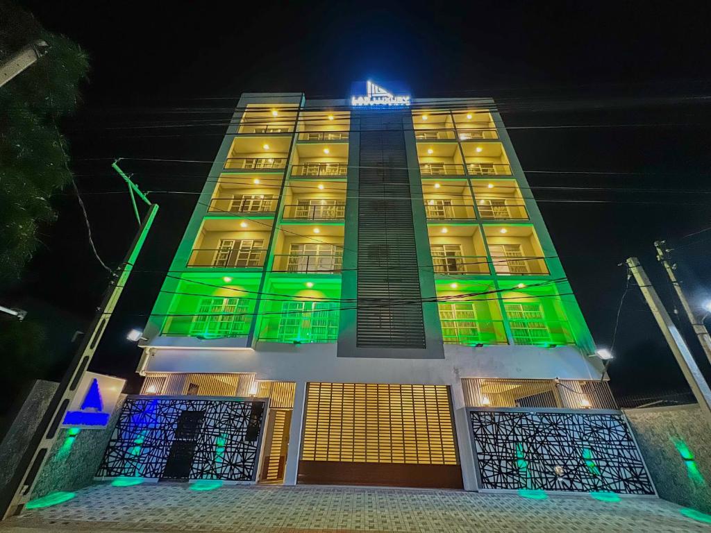 a building with green and yellow lights on it at LAR LUXURY APARTMENTS in Colombo