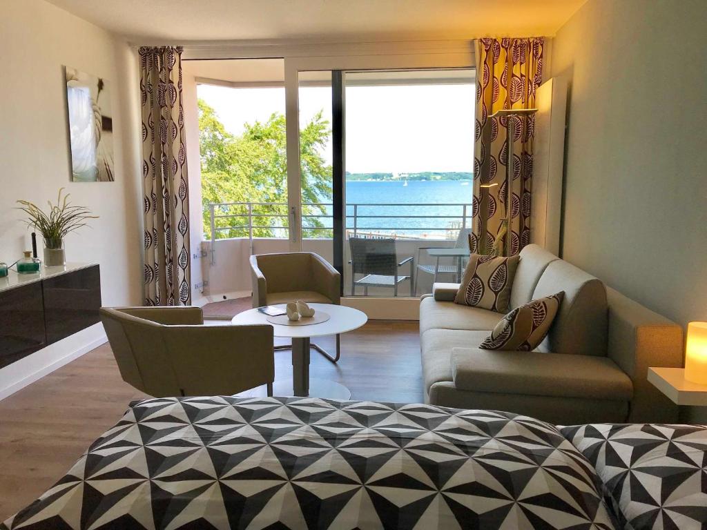 a living room with a view of the ocean at Appartement _An der Seebruecke_ in Glücksburg