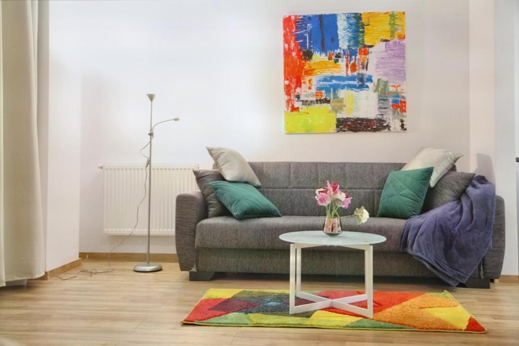 a living room with a couch and a table at Luxury Downtown Apartment in Cluj-Napoca