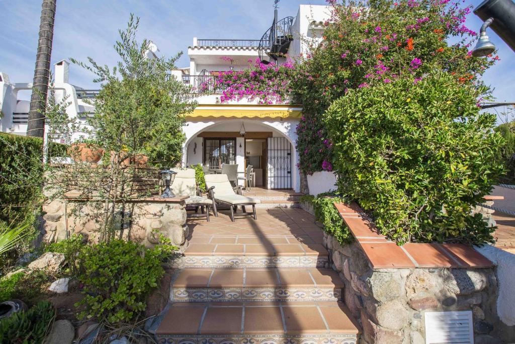 a house with a garden with flowers and plants at BayMar by MarCalma in Montroig