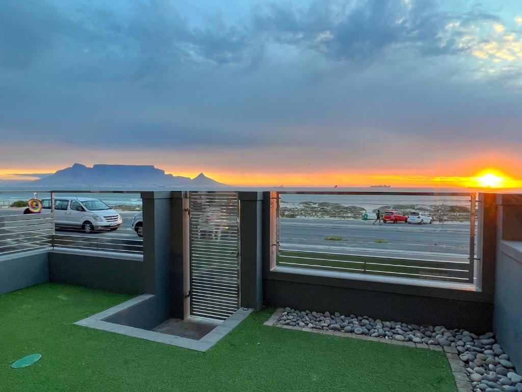 a balcony with a view of a parking lot at Seacrest Luxury Beachfront Apartment - Blouberg Beach in Bloubergstrand
