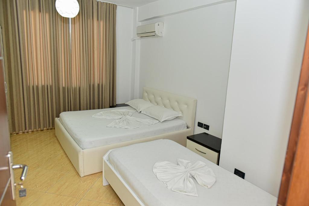 Postel nebo postele na pokoji v ubytování Hotel Tomorri
