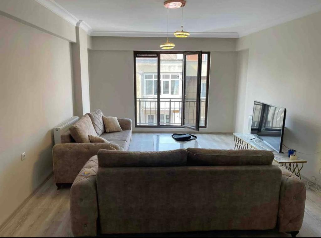 a living room with two couches and a large window at BURSA TELEFERIK 4 1 DUPLEX apartment in Yıldırım