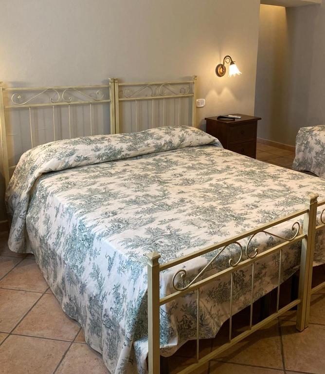 A bed or beds in a room at Affittacamere La Torre di Montalcino