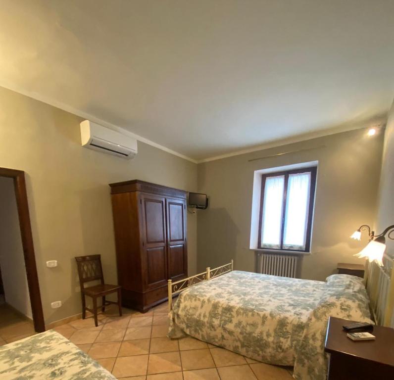 A bed or beds in a room at Affittacamere La Torre di Montalcino