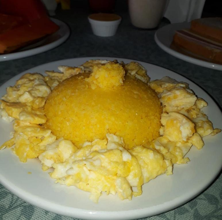 a white plate of food on a table at Pousada Brilho dos Lençóis in Barreirinhas