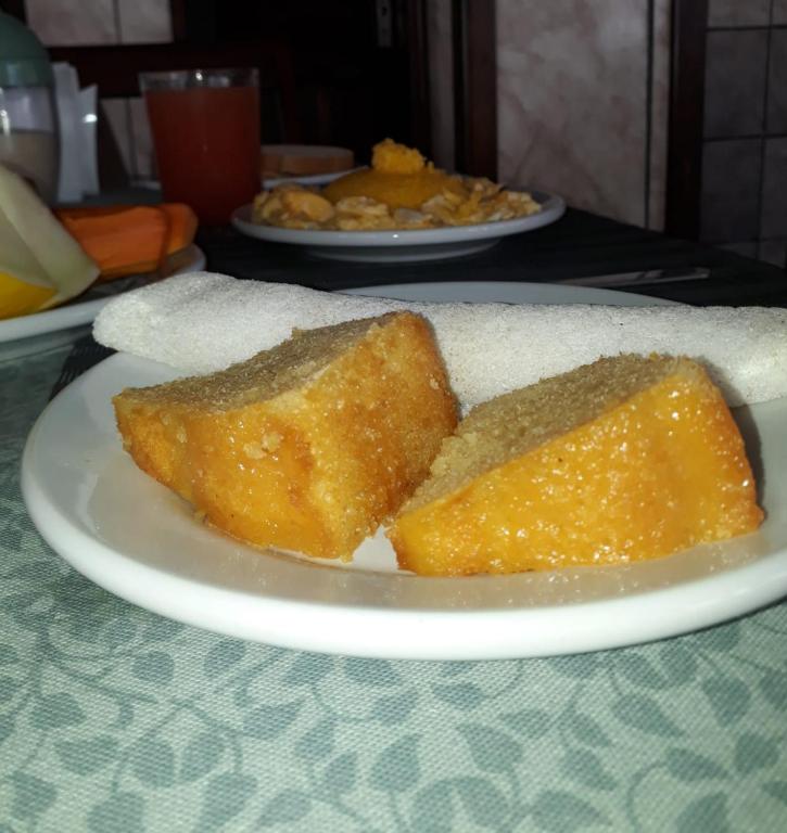 a piece of cake on a plate on a table at Pousada Brilho dos Lençóis in Barreirinhas