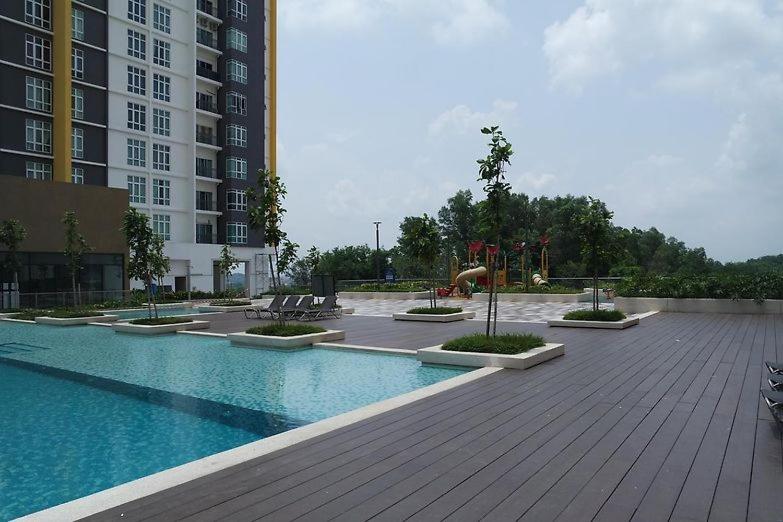 a swimming pool with a playground in a building at Camellia Mesahill Homestay in Nilai