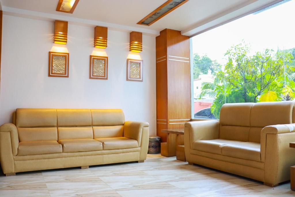a waiting room with two couches and a window at Cox Hill Tower in Cox's Bazar