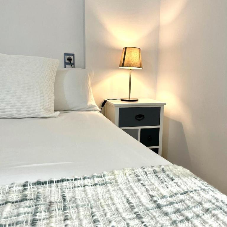 a bedroom with a bed with a lamp on a night stand at Taina La Envia Golf in La Envia