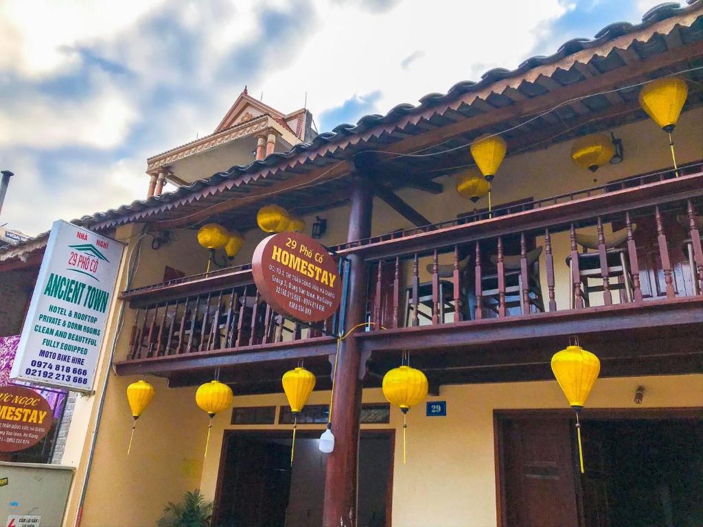 a building with yellow lamps on the side of it at Ancient Town 29 Phố Cổ in Dồng Văn