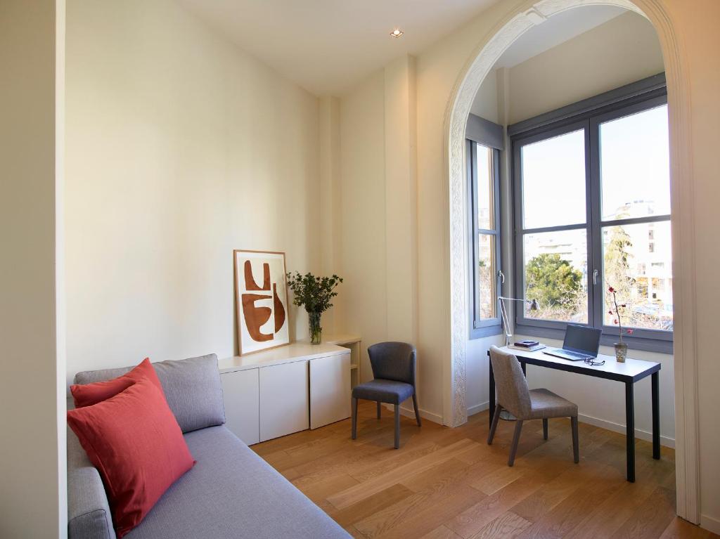 a living room with a couch and a table with a laptop at Del Taso 1850 in Athens