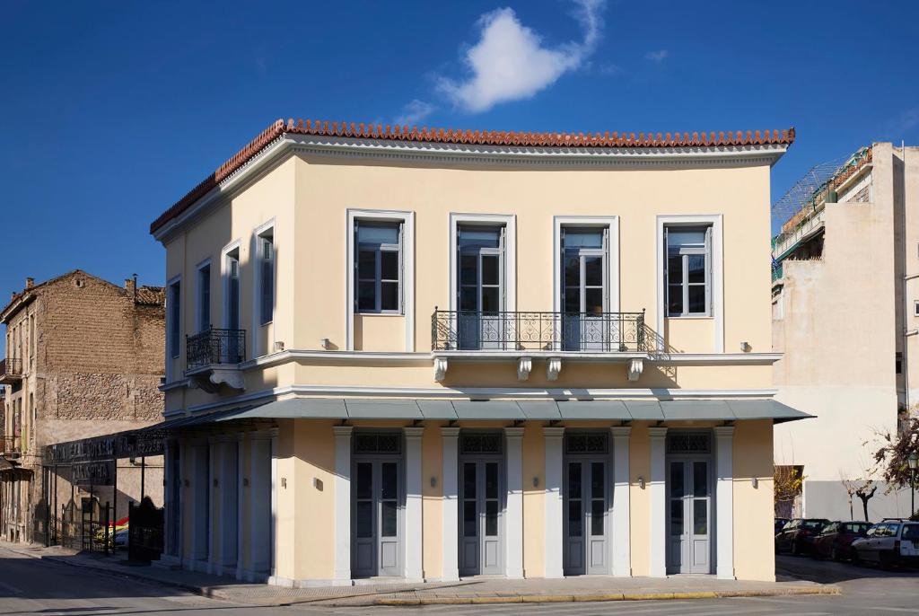 a white building with a balcony on top of it at Del Taso 1850 in Athens