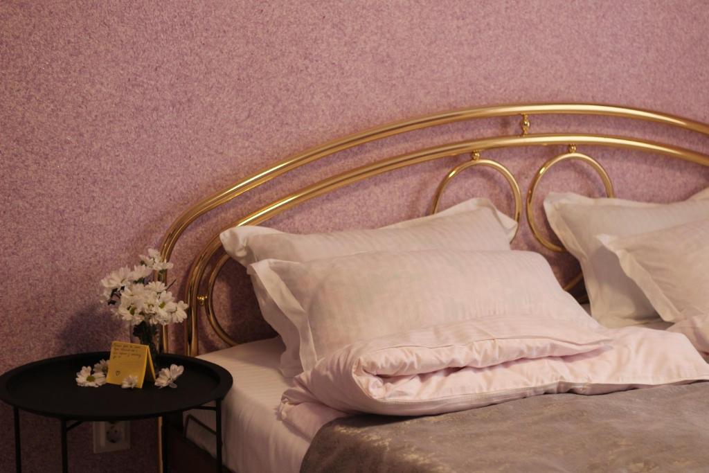 斯辛訥查的住宿－Котедж UKO，一张带白色床单和枕头的床以及一张带鲜花的桌子