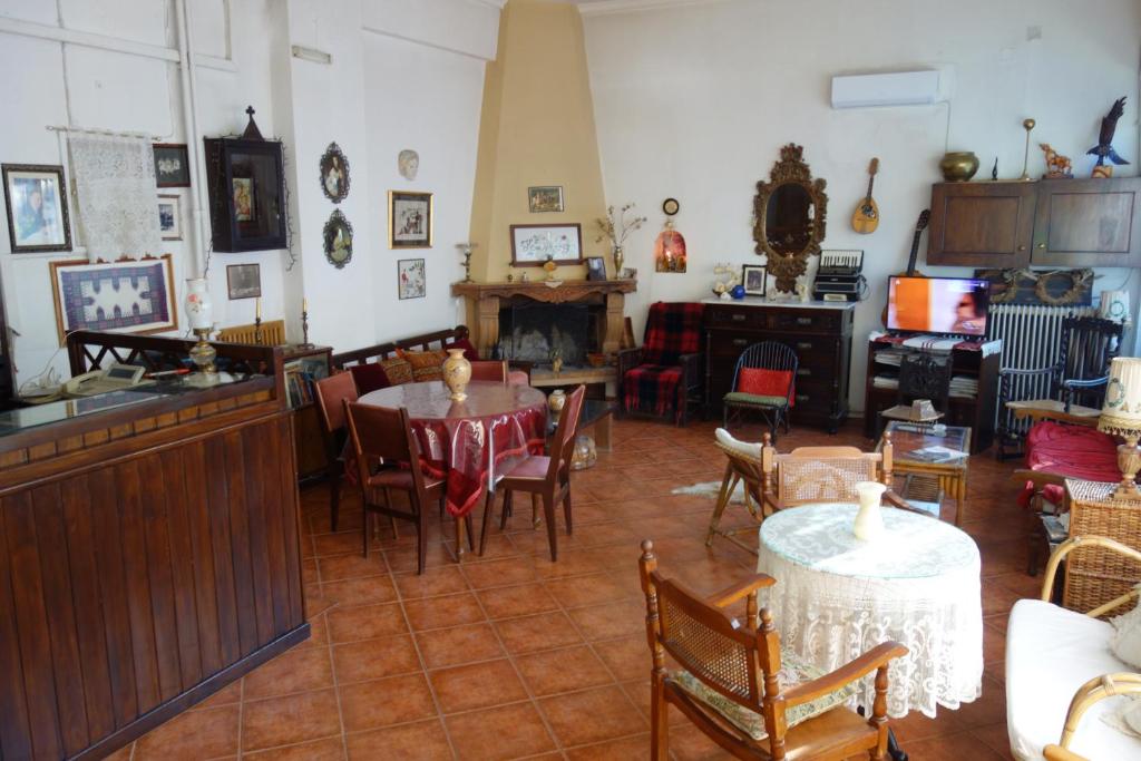 a living room with tables and chairs and a fireplace at ARION in Vília