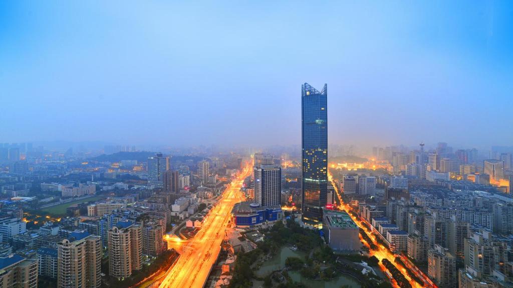 a city at night with a tall building and traffic at InterContinental Fuzhou in Fuzhou