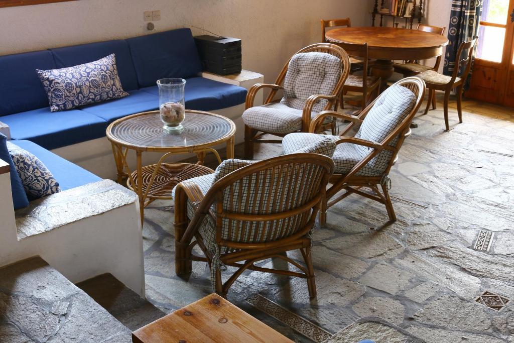 a living room with chairs and a couch and tables at Villa Oleander in Spetses