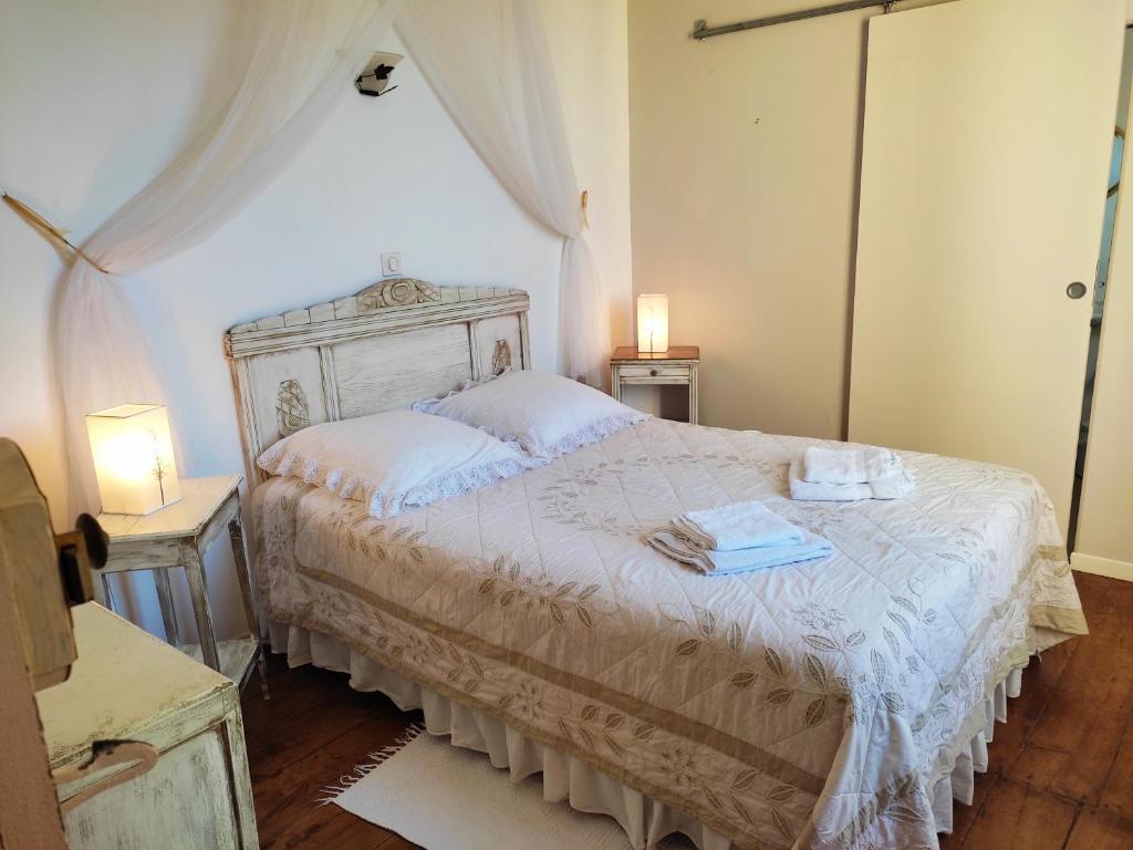 a bedroom with a bed with two towels on it at Les Angelots in Condom