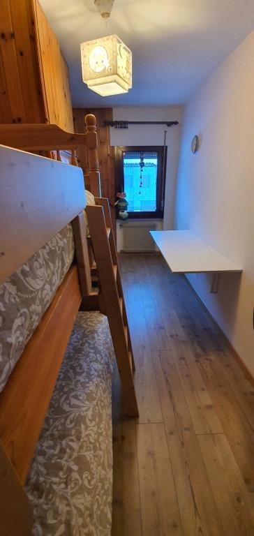 A bed or beds in a room at Appartamento Piano terra - Marmolada - Rocca Pietore - Boscoverde
