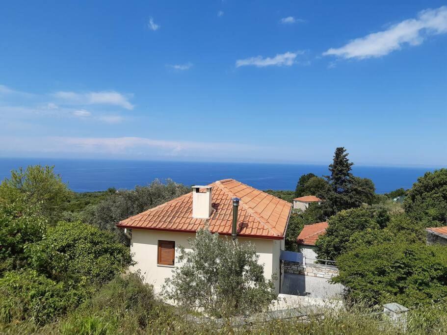 a small white house with a red roof at Kouros Villa! in Paltsi Pilion