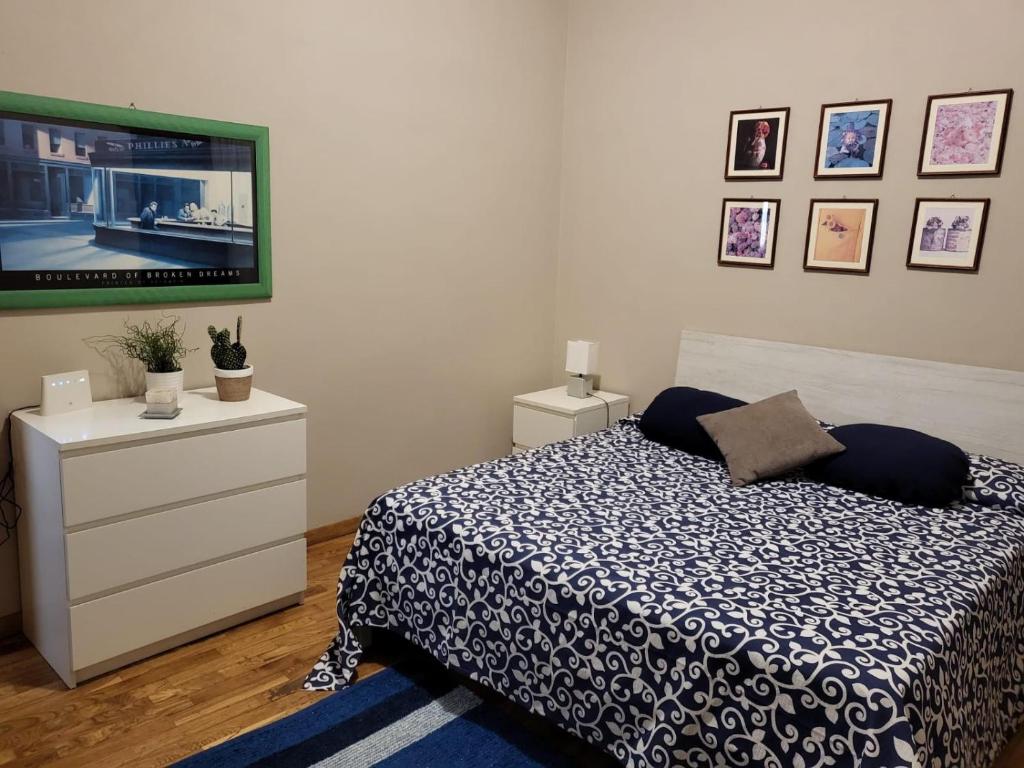 a bedroom with a bed and a tv on a dresser at Casa da Michelino in Palermo