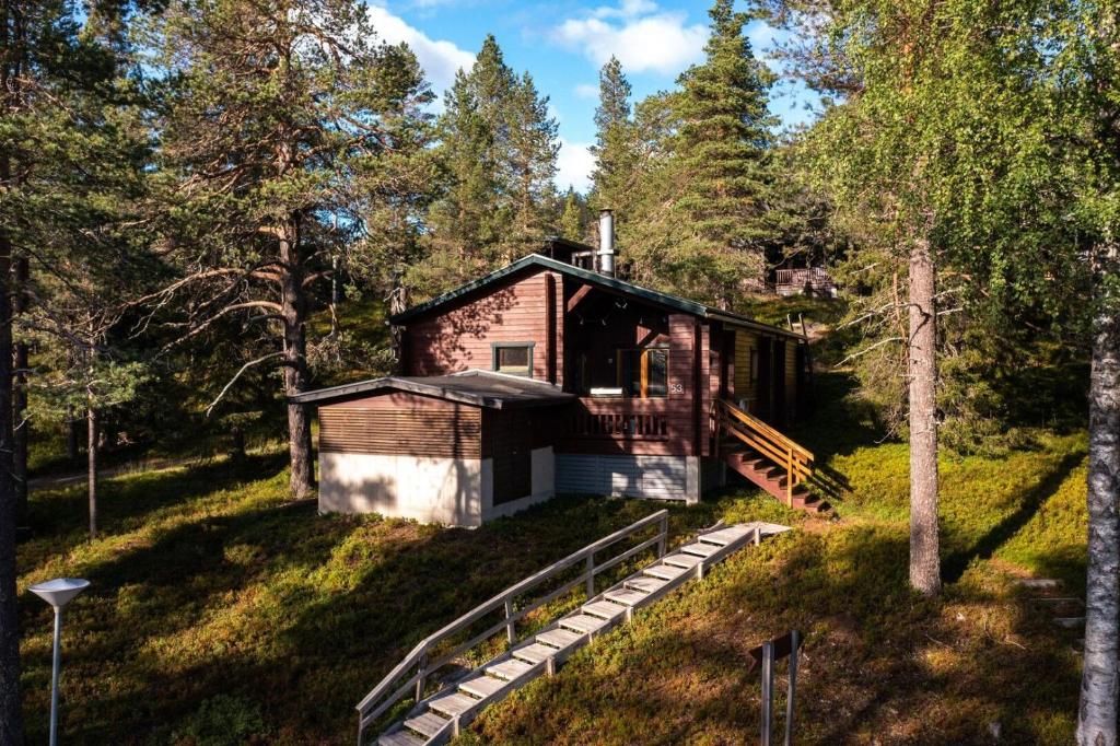 a log cabin in the woods with trees at Ruka Villa Kieppi in Ruka