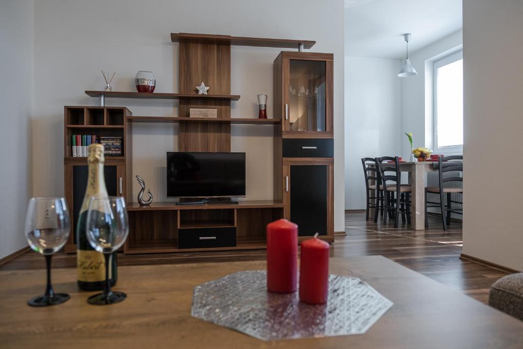 a living room with a bottle of wine and a wine glass at SGL apartment Liptovska with free parking in Trenčín