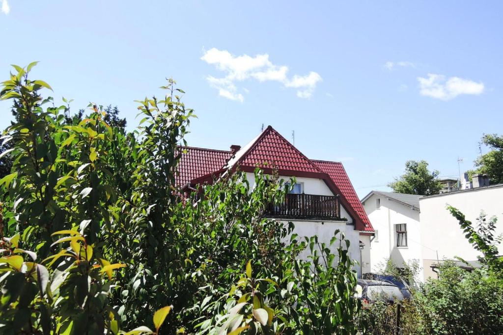 a white house with a red roof at Holiday flat, Miedzyzdroje in Międzyzdroje