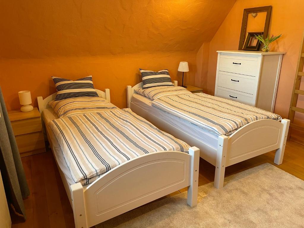 two beds sitting next to each other in a room at Gästezimmer Adenau in Adenau