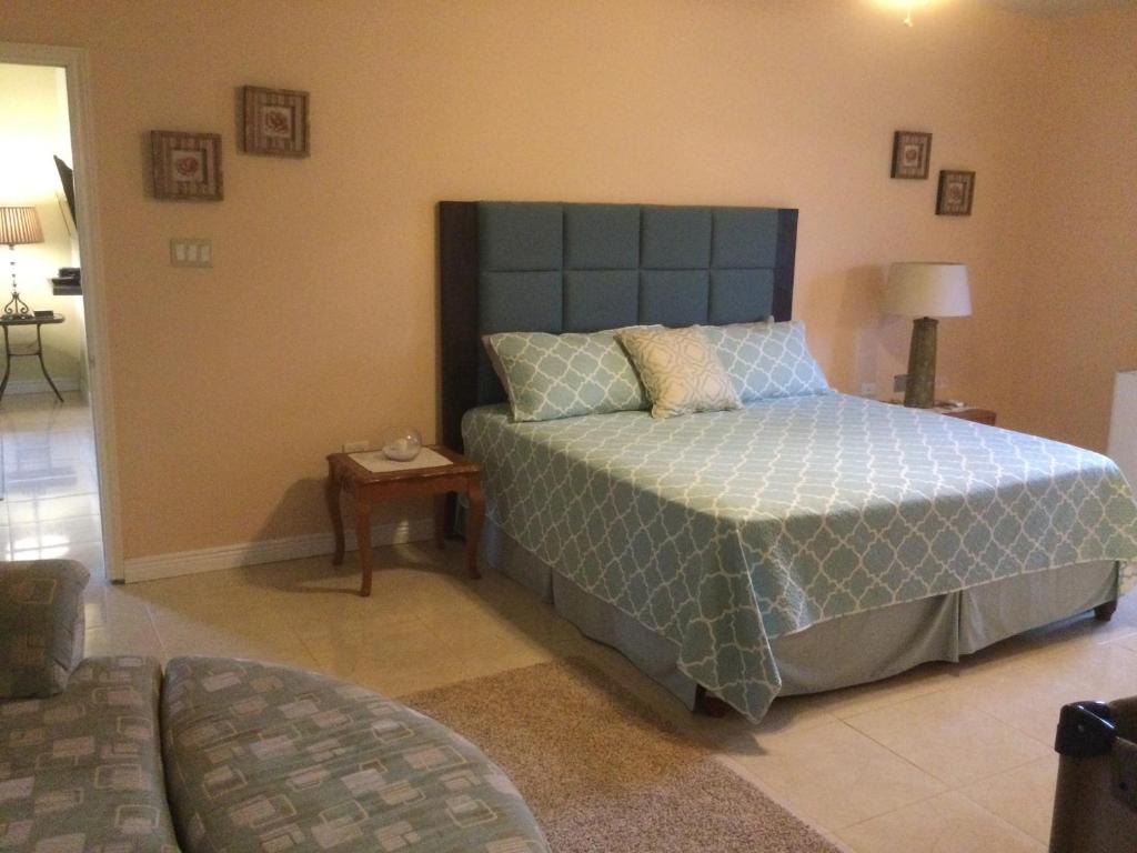 a bedroom with a large bed and a table at Mountain View retreat st.Elizabeth in Far Enough