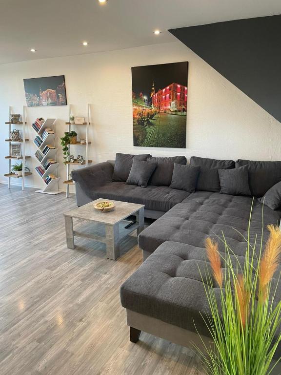 a living room with a couch and a coffee table at Ferienhaus-Weitsicht in Sankt Wendel