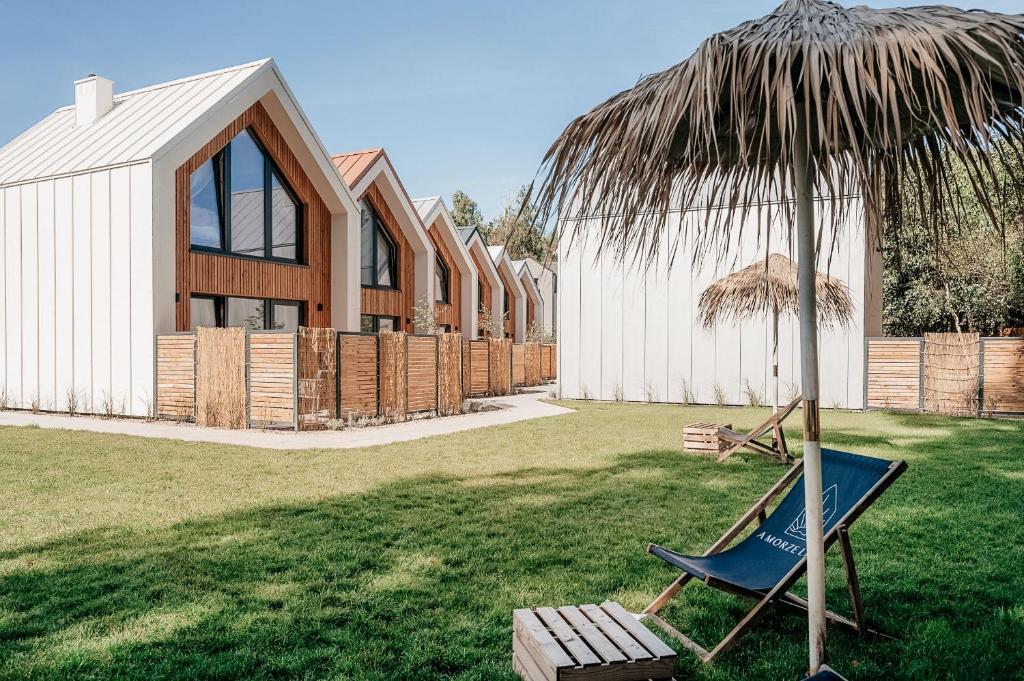 a hammock and an umbrella in a yard with a house at AMORZELAS in Dębki