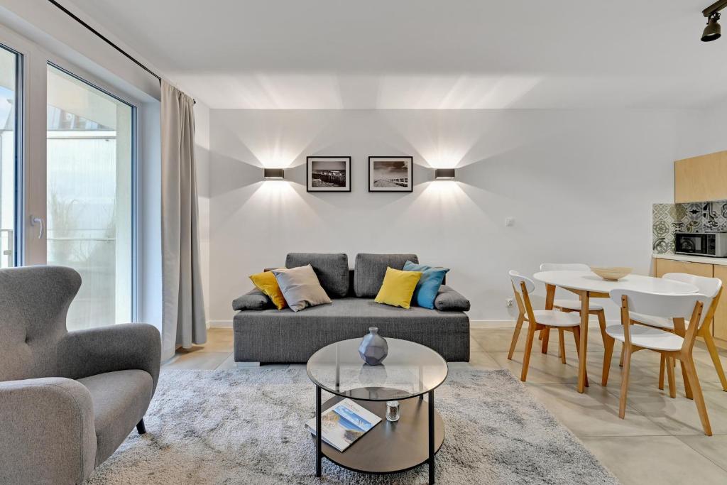 a living room with a couch and a table at Dom & House - Apartments Angielska Grobla in Gdańsk