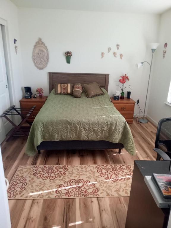 a bedroom with a bed and a wooden floor at Room in Campbell with Own Bthrm in Campbell