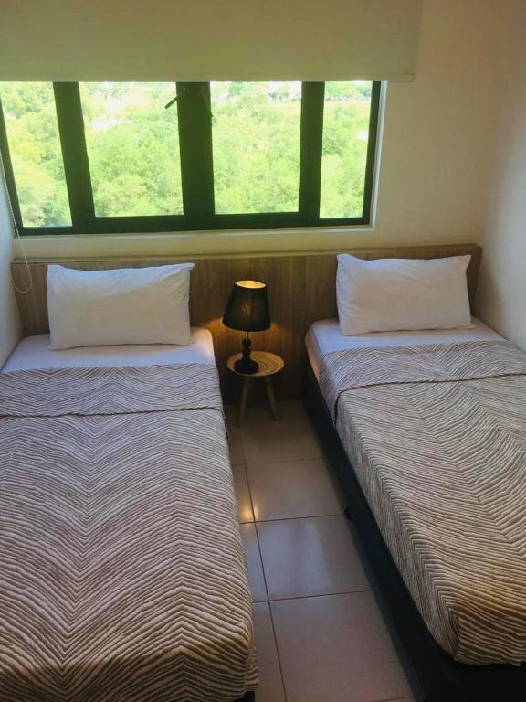 Postel nebo postele na pokoji v ubytování Imperio Homestay Alor Star