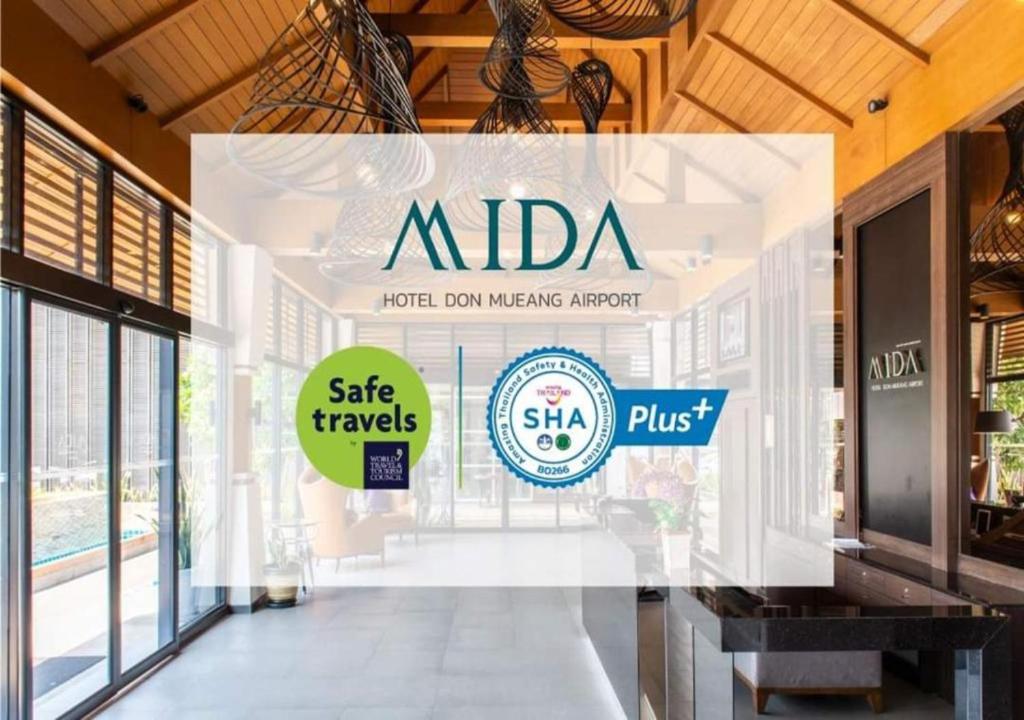 The entrance lobby is shown behind a large Safe Travels and SHA Plus overlay.