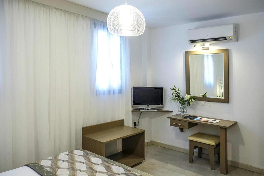 A television and/or entertainment centre at Apartment in Elia Beach for 2 Person