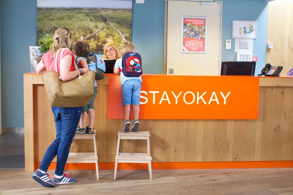 a group of children standing at a counter in a store at Stayokay Hostel Egmond in Egmond-Binnen