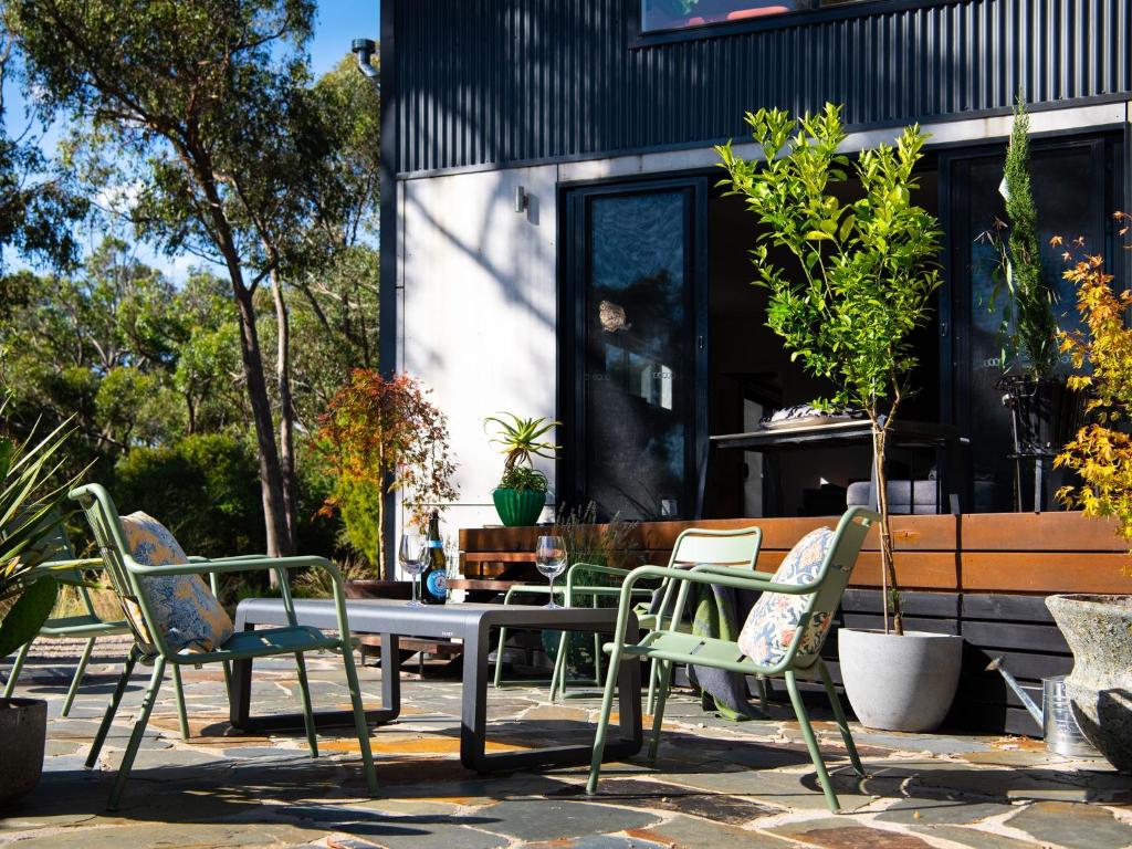 a patio with a table and chairs and a building at Retreat@ 34A in Daylesford